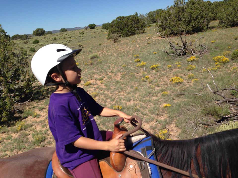 Kaiden on his first trail ride being ponied.